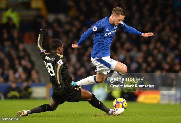 Daniel Amartey of Leicester City tackles Gylfi Sigurdsson of Everton during the Premier League match between Everton and Leicester City at Goodison...