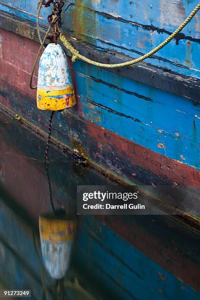 old fishing boat with bouy handing over the edge - bouy stock pictures, royalty-free photos & images