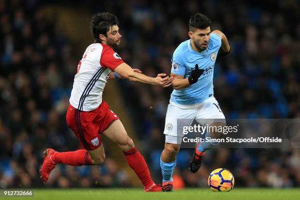 Sergio Aguero of Man City battles with Claudio Yacob of West Brom during the Premier League match between Manchester City and West Bromwich Albion at...