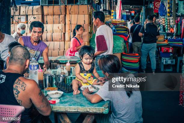 street vendor at market in manila, philippines - philippines family celebration stock pictures, royalty-free photos & images