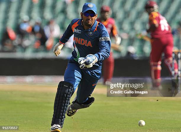 Mahendra Singh Dhoni of India chases a loose ball during The ICC Champions Trophy Group A Match between India and West Indies at Wanderers Stadium on...