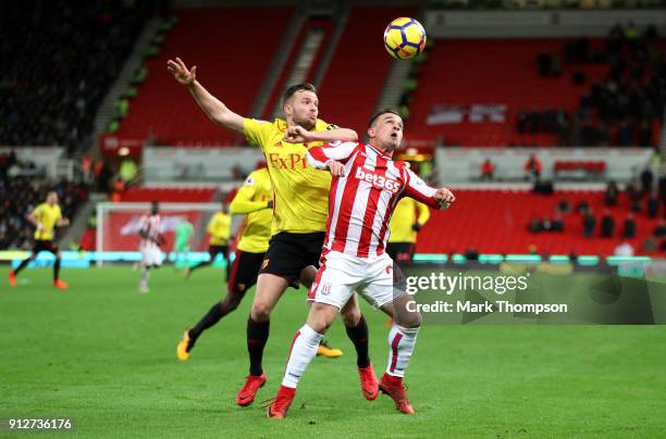 Tom Cleverley of Watford challenges Xherdan Shaqiri of Stoke City during the Premier League match between Stoke City and Watford at Bet365 Stadium on...