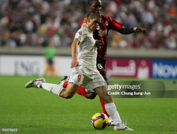 Magno Alves of Umm-Salal in action against Adilson Dos Santos of Seoul during the AFC Champions League match between FC Seoul and Umm-Salal at Seoul...