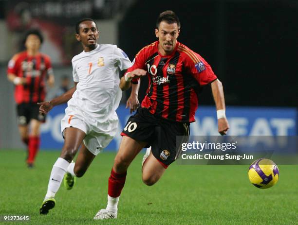 Dejan Damjanovic of Seoul and Mustafa Adan of Umm-Salal compete for the ball during the AFC Champions League match between FC Seoul and Umm-Salal at...