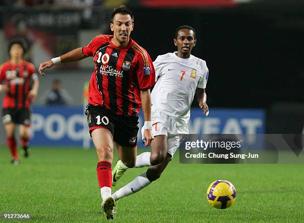 Dejan Damjanovic of Seoul and Mustafa Adan of Umm-Salal compete for the ball during the AFC Champions League match between FC Seoul and Umm-Salal at...