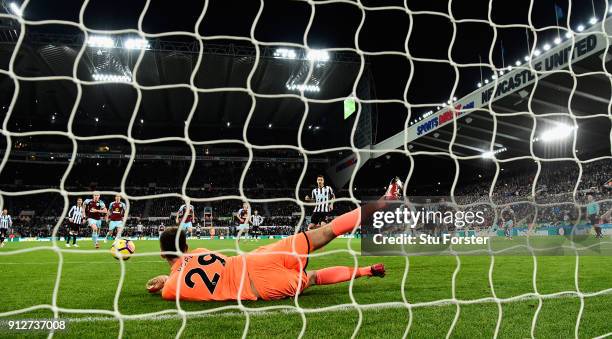 Burnley goalkeeper Nick Pope dives to save the penalty by Newcastle player Joselu during the Premier League match between Newcastle United and...