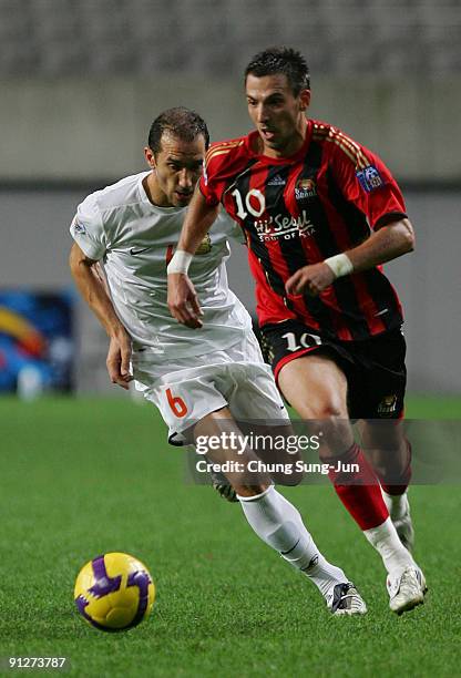 Dejan Damjanovic of FC Seoul and Ben Askar of Umm-Salal compete for the ball during the AFC Champions League match between FC Seoul and Umm-Salal at...