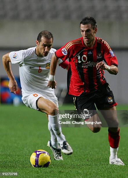 Dejan Damjanovic of Seoul and Ben Askar of Umm-Salal compete for the ball during the AFC Champions League match between FC Seoul and Umm-Salal at...