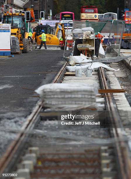 Workmen continue works on the Edinburgh tram project on Princes Street on September 30, 2009 in Edinburgh, Scotland. The final cost of the project is...