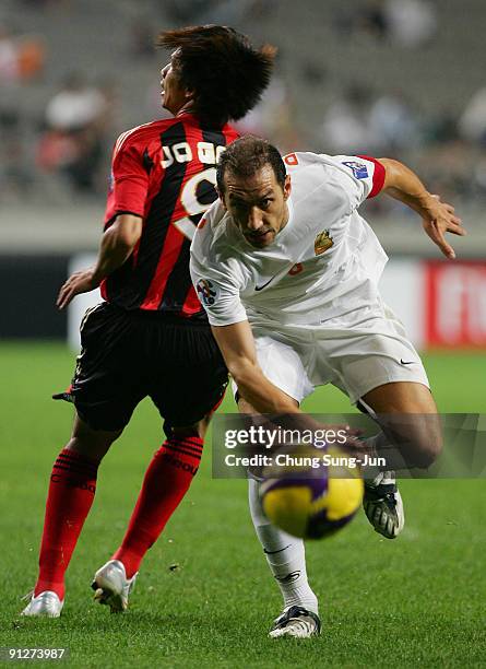 Ben Askar of Umm-Salal evades a challenge from Jung Jo-Gook of Seoul during the AFC Champions League match between FC Seoul and Umm-Salal at Seoul...