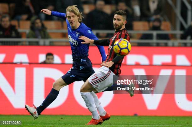 Dusan Basta of SS Lazio compete for the ball with Fabio Borini of AC Milan during the TIM Cup match between AC Milan and SS Lazio at Stadio Giuseppe...