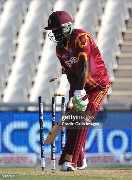 Travis Dowlin of the West Indies is bowled by Mahendra Singh Dhoni of India for 14 runs during The ICC Champions Trophy Group A Match between India...