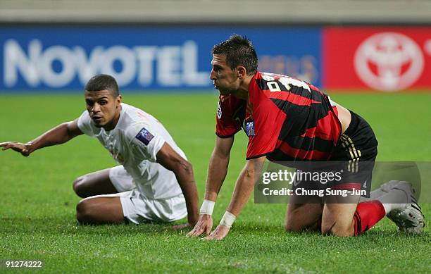 Damjanovic DeJan of Seoul and Mohamed Husain of Umm-Salal get up after competing for the ball during the AFC Champions League match between FC Seoul...