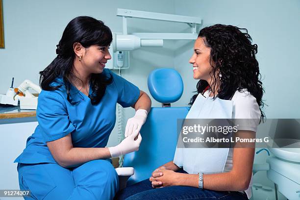 dentist and patience - pre treatment talking - gloves clasped hands ストックフォトと画像