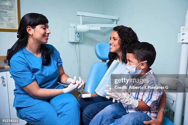 dentist and patiences - pre treatment talking - gloves clasped hands ストックフォトと画像