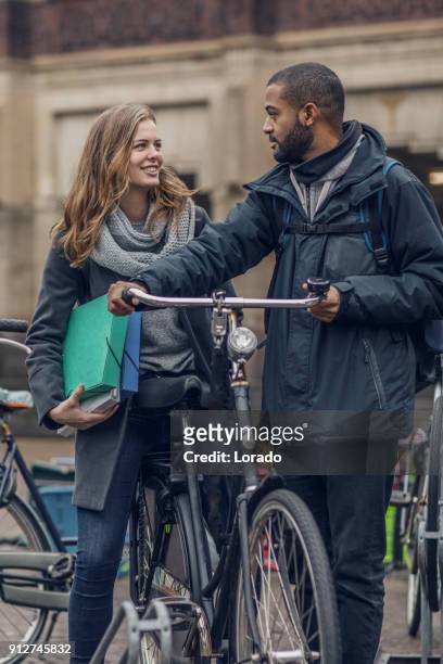 multi ethnic university student couple going to classes in the netherlands - international student day stock pictures, royalty-free photos & images