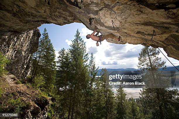 man rock climbing horizontal roof - spokane stock pictures, royalty-free photos & images