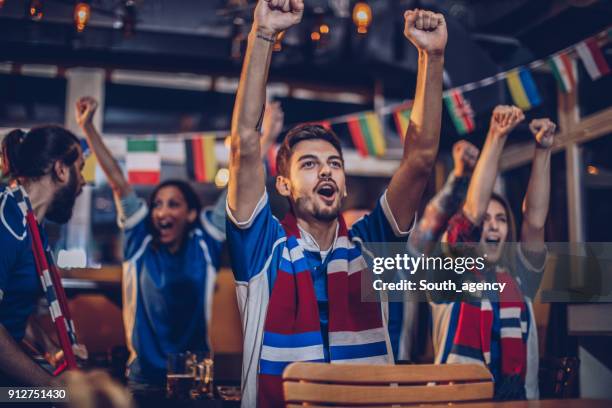 friends at sport bar - supporter scarf stock pictures, royalty-free photos & images