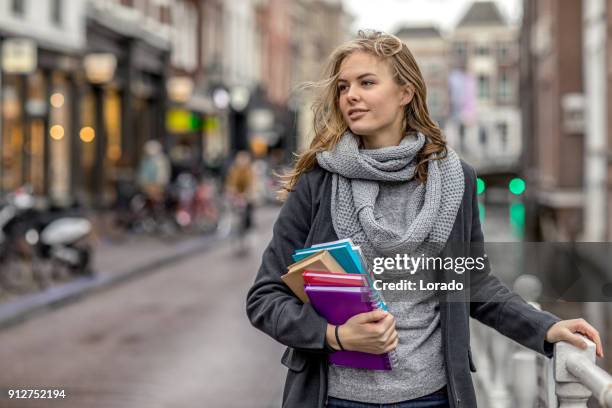 beautiful female university student studying outdoors in delft city centre - linguistics stock pictures, royalty-free photos & images