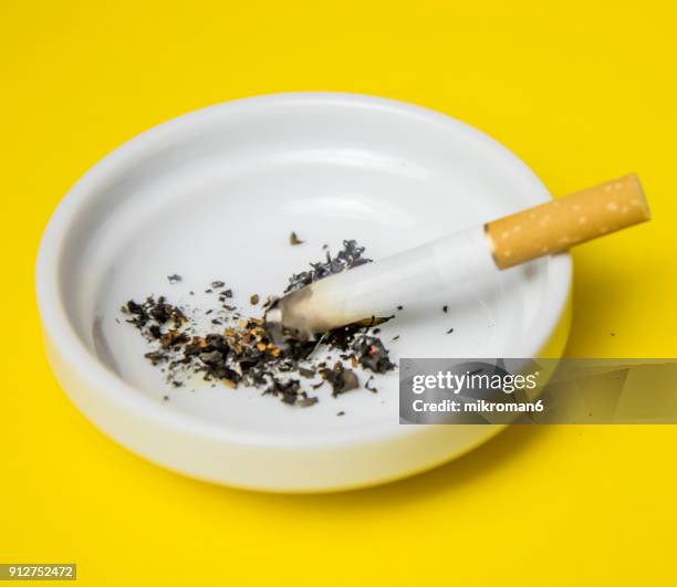 cigarettes and butts in ashtray - zigarettenfilter stock-fotos und bilder