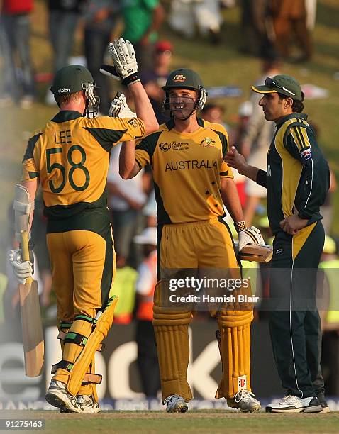 Brett Lee and Nathan Hauritz of Australia celebrate victory during the ICC Champions Trophy Group A match between Australia and Pakistan played at...