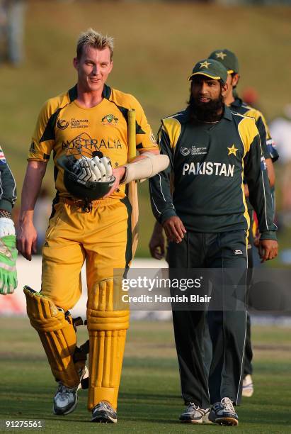 Brett Lee of Australia and Mohammad Yousuf of Pakistan leave the field at the end of the match during the ICC Champions Trophy Group A match between...