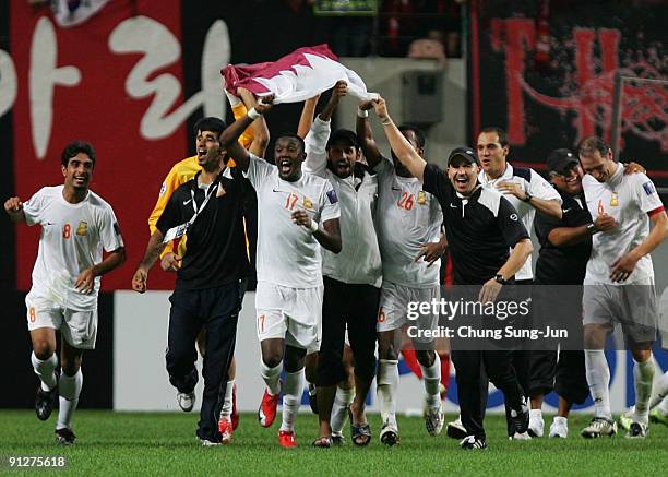 Umm Salal's players with a Qatar national flag celebrate after winning the AFC Champions League match between FC Seoul and Umm-Salal at Seoul World...