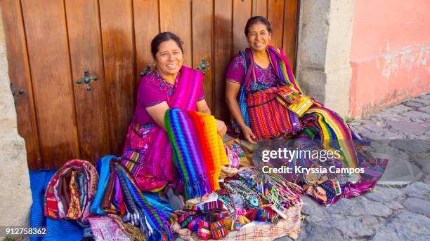mayan women selling handmade textiles and souvenirs, antigua, guatemala - guatemala bildbanksfoton och bilder