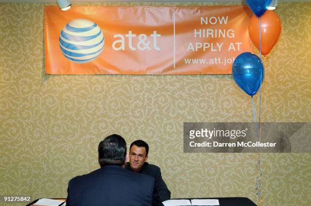 Area Retail Sales Manager Joshua Mailloux interviews a prospective employee at an AT&T job fair September 30, 2009 at the Hilton Dedham in Dedham,...