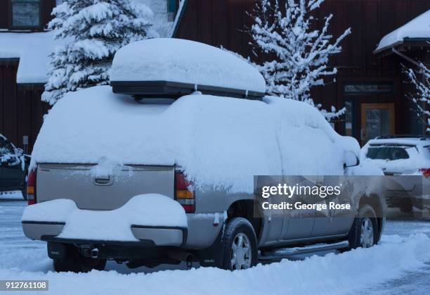 Light dusting of snow from a fast-moving overnight storm coats a parked vehicle at the Riva Grill Boat Marina on January 25 in South Lake Tahoe,...