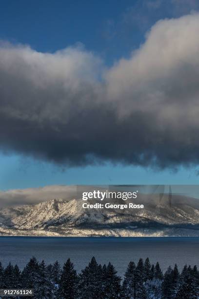 Mt. Tallac and surrounding mountains reveal a light dusting of snow from a fast-moving overnight storm on January 25 in South Lake Tahoe, California....