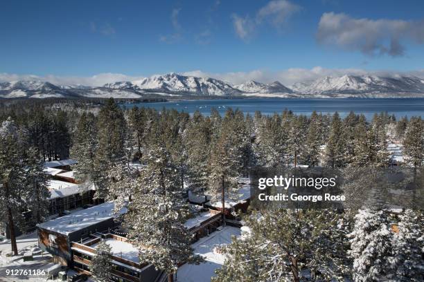 Light dusting of snow from a fast-moving overnight storm coats the trees around the Base Camp Hotel on January 25 in South Lake Tahoe, California....