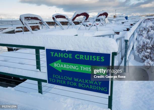 Light dusting of snow from a fast-moving overnight storm coats the Riva Grill Boat Marina on January 25 in South Lake Tahoe, California. Though a...