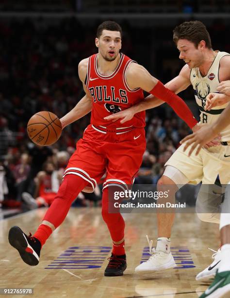 Zach LaVine of the Chicago Bulls moves against Matthew Dellavedova of the Milwaukee Bucks at the United Center on January 28, 2018 in Chicago,...