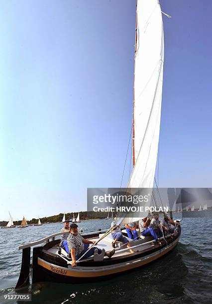 Participants of the 12th traditional Croatian wooden lateen sail boats regatta also named �gajetas�, sail past the Croatian central Adriatic island...