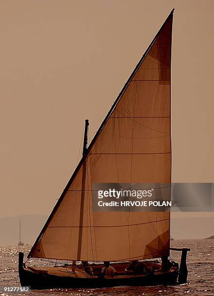 Participants of the 12th traditional Croatian wooden lateen sail boats regatta also named �gajetas�, sail past the Croatian central Adriatic island...