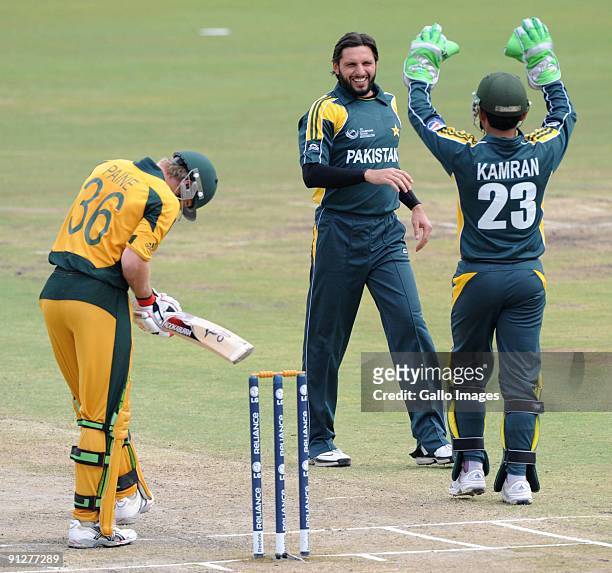 Shahid Afridi of Pakistan and Kamran Akmal of Pakistan celebrate the wicket of Tim Paine of Australia during the ICC Champions Trophy match between...