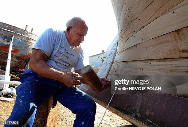 Cedomir Butina works on a traditional Croatian wooden boat named �gajeta� in his small shipyard in town of Betina, on Murter island, some 300...