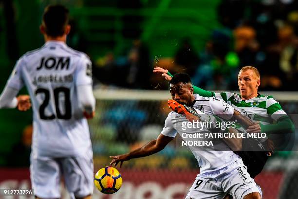 Sporting's French defender Jeremy Mathieu vies with Guimaraes' Ivorian forward Tallo Junior during the Portuguese League football match Sporting CP...