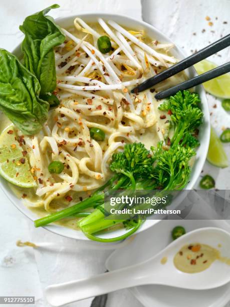 green curry noodle soup with broccolini, bean sprouts and fresh basil, - curry soup stock pictures, royalty-free photos & images