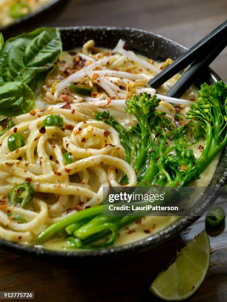 green curry noodle soup with broccolini, bean sprouts and fresh basil, - curry soup stock pictures, royalty-free photos & images