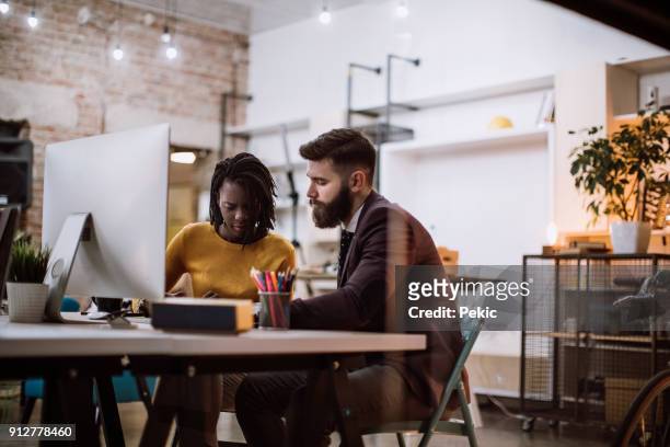colleagues working in front of computer monitor - creative director stock pictures, royalty-free photos & images