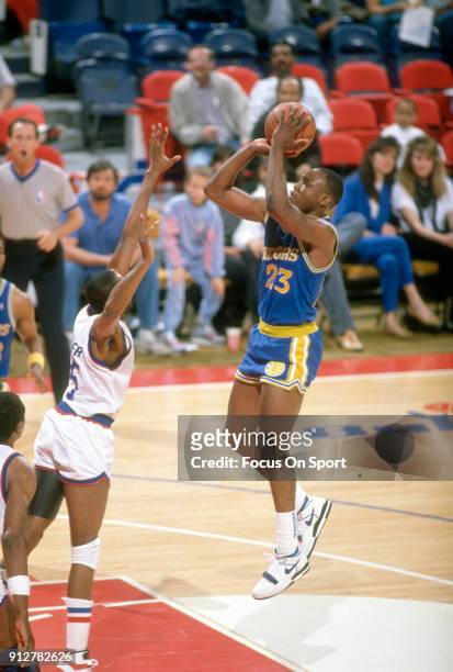 Mitch Richmond of the Golden State Warriors shoots over Darryl Walker of the Washington Bullets during an NBA basketball game circa 1989 at the...