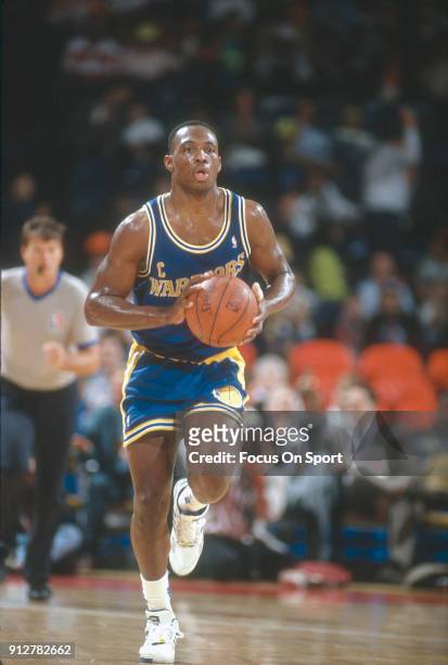 Mitch Richmond of the Golden State Warriors looks to pass the ball up court against the Washington Bullets during an NBA basketball game circa 1990...