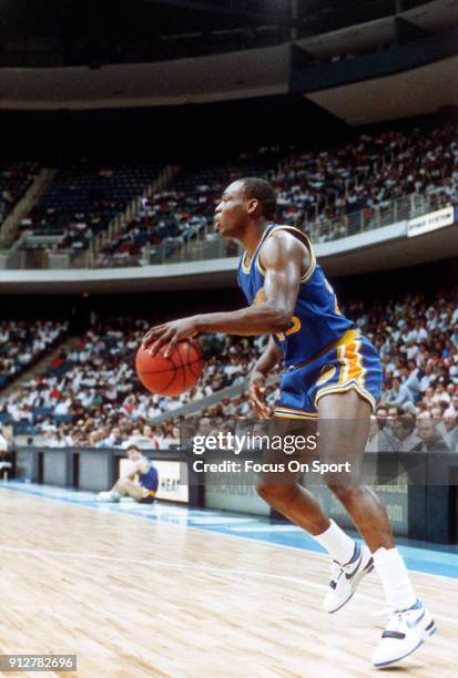 Mitch Richmond of the Golden State Warriors dribbles the ball against the Miami Heat during an NBA basketball game circa 1989 at the Miami Arena in...