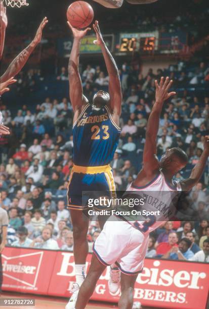 Mitch Richmond of the Golden State Warriors shoots over Haywoode Workman of the Washington Bullets during an NBA basketball game circa 1990 at the...