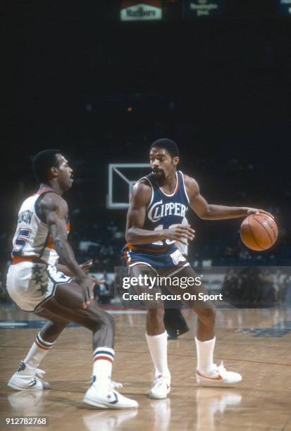 Norm Nixon of the San Diego Clippers dribbles the ball while guarded by Frank Johnson of the Washington Bullets during an NBA basketball game circa...