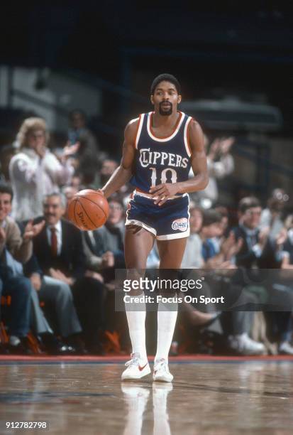 Norm Nixon of the Los Angeles Clippers dribbles the ball up court against the Washington Bullets during an NBA basketball game circa 1984 at the...