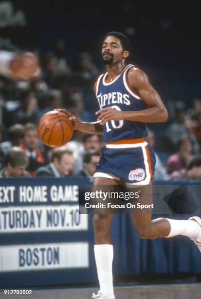 Norm Nixon of the Los Angeles Clippers dribbles the ball up court against the Washington Bullets during an NBA basketball game circa 1984 at the...