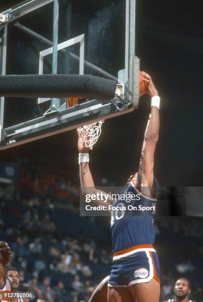 Norm Nixon of the Los Angeles Clippers goes up for a slam dunk against the Washington Bullets during an NBA basketball game circa 1984 at the Capital...